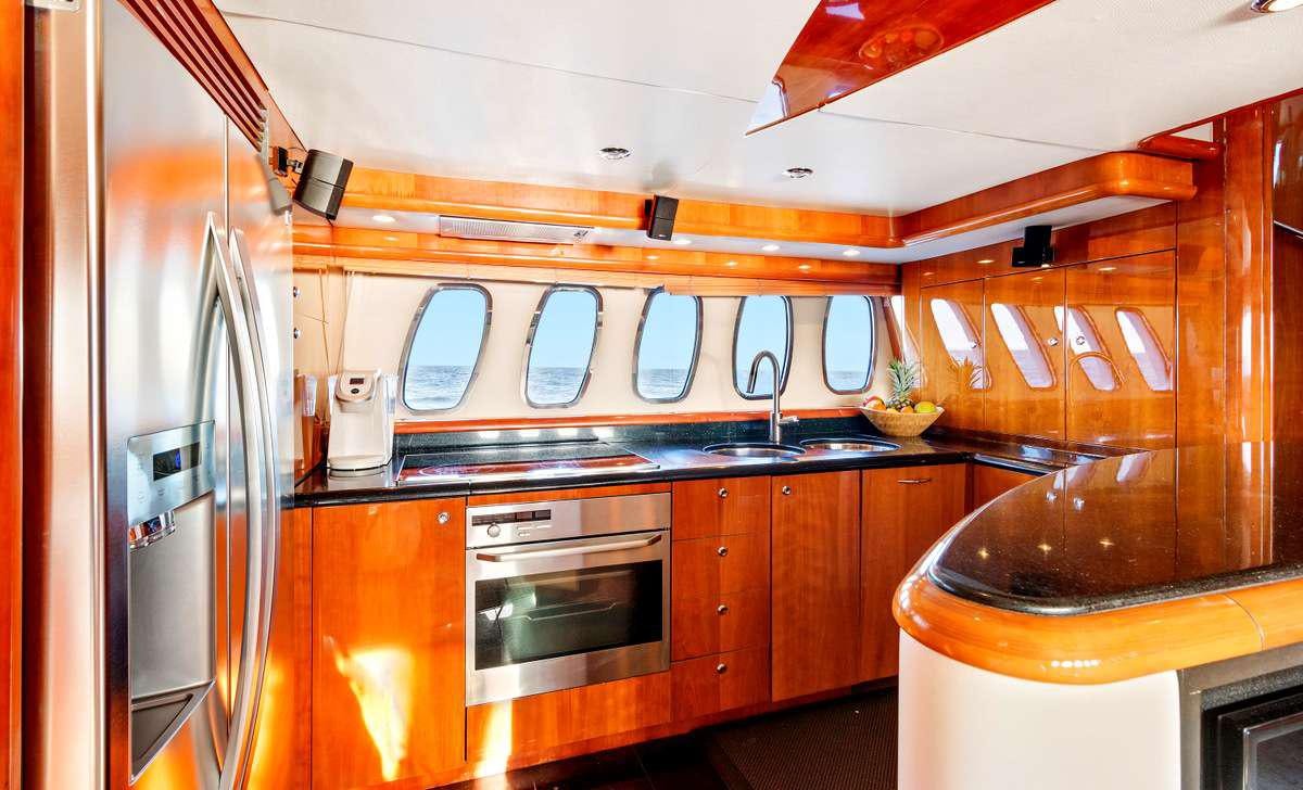 a kitchen with wooden cabinets aboard PRIVEE Yacht for Charter