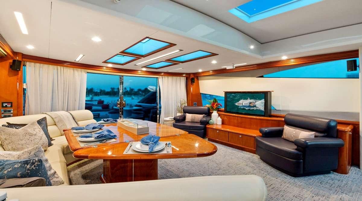 a living room with a large window aboard PRIVEE Yacht for Charter