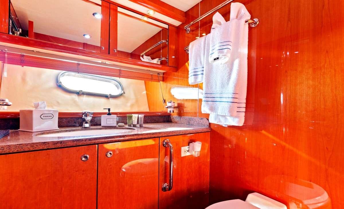 a kitchen with wooden cabinets aboard PRIVEE Yacht for Charter