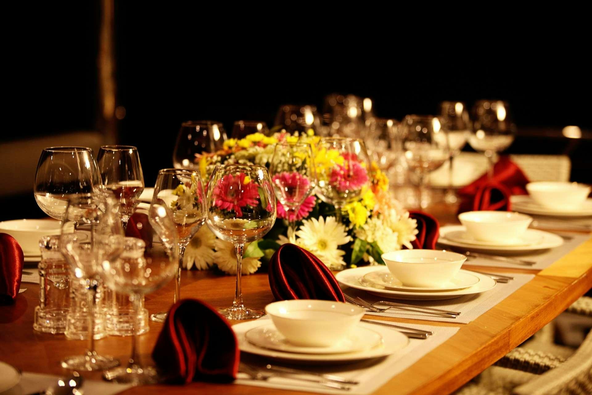 a table with glasses and plates of food on it aboard CROCUS Yacht for Charter