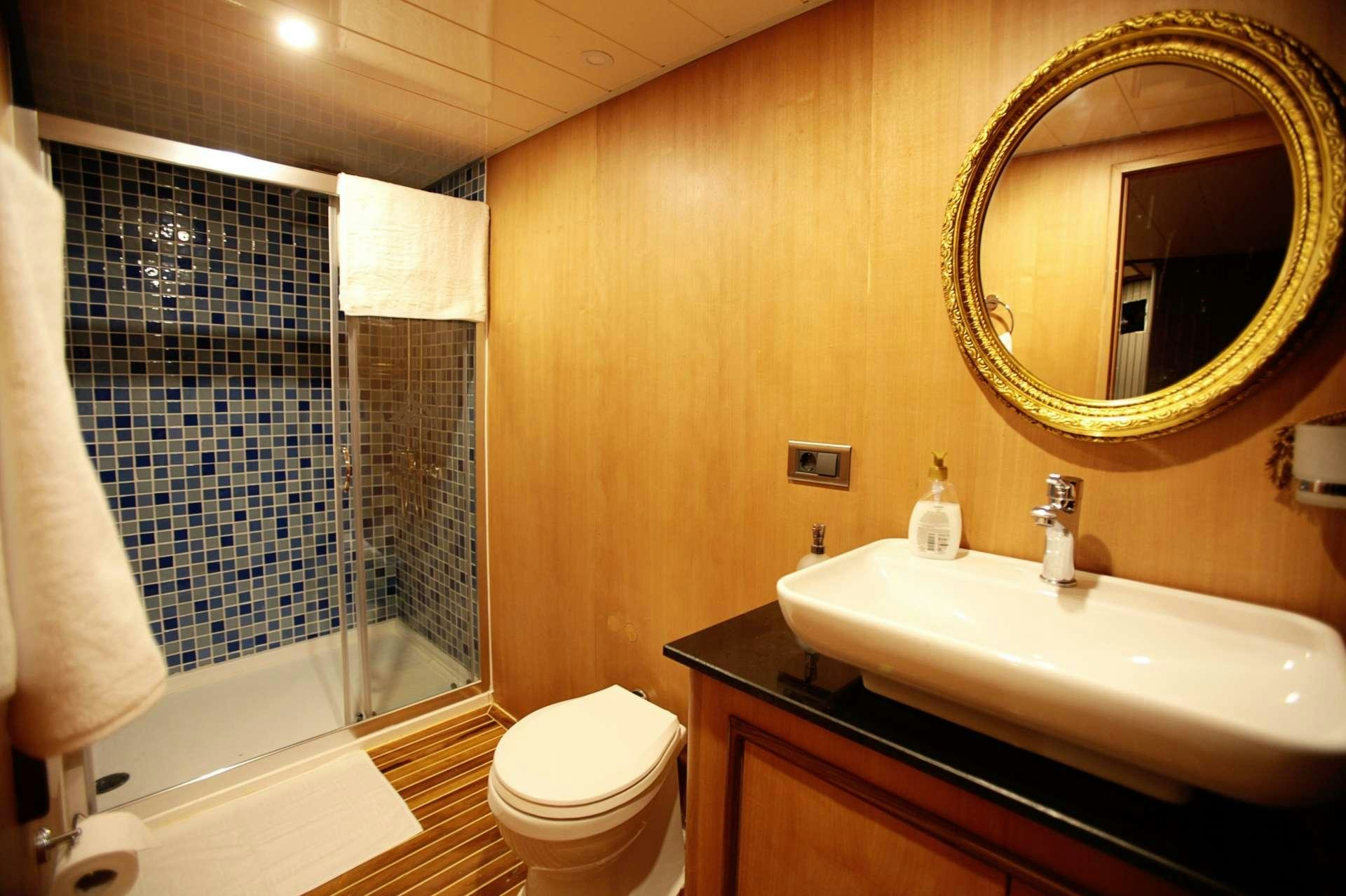 a bathroom with a sink and a toilet aboard CROCUS Yacht for Charter