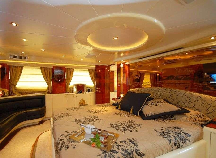 a room with a bed and a table with a cloth on it aboard CROCUS Yacht for Charter
