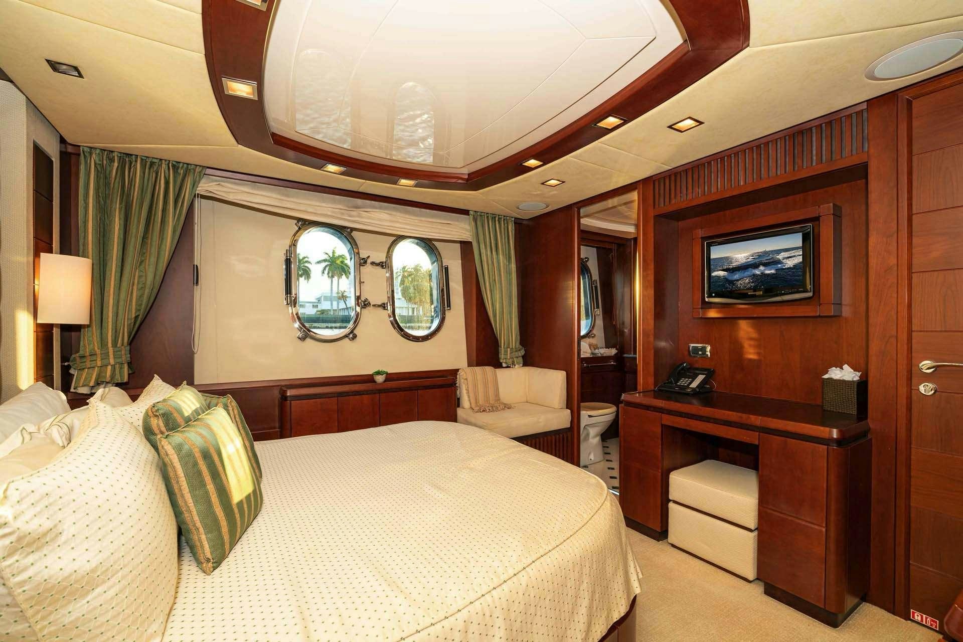 a hotel room with a bed and a tv aboard VIVERE Yacht for Charter