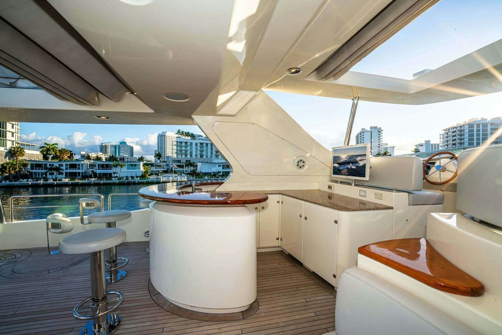 a large white kitchen with a large window overlooking a city aboard VIVERE Yacht for Charter