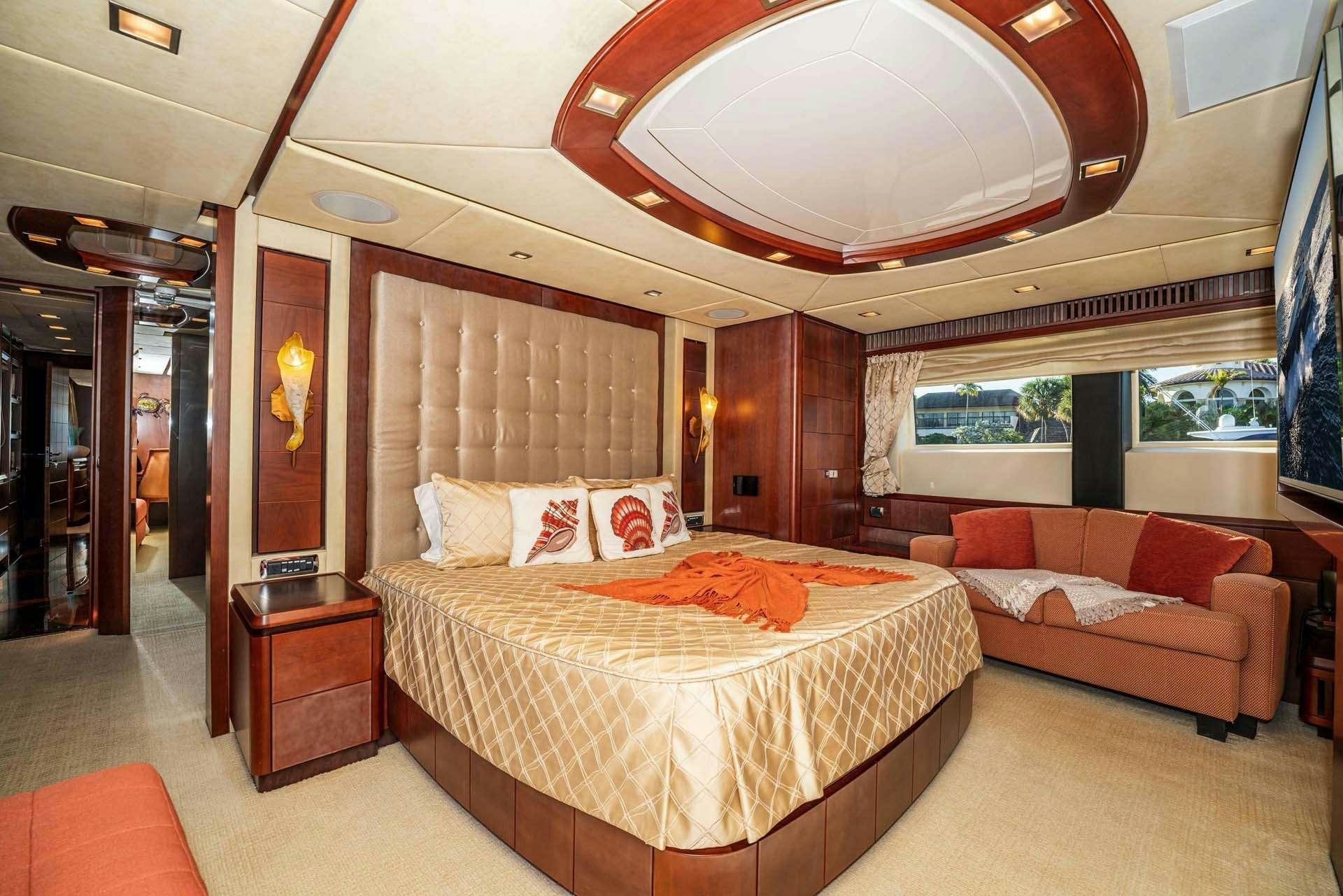 a room with a bed and a couch aboard VIVERE Yacht for Charter