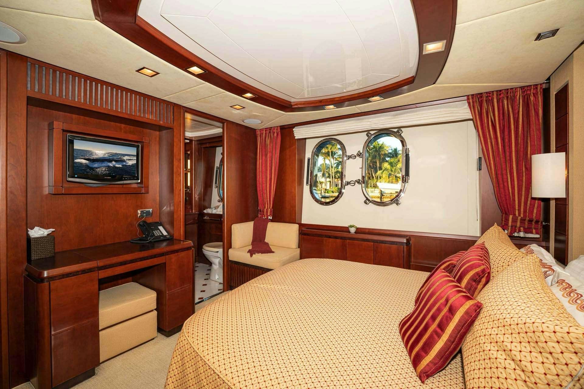 a bedroom with a large bed aboard VIVERE Yacht for Charter