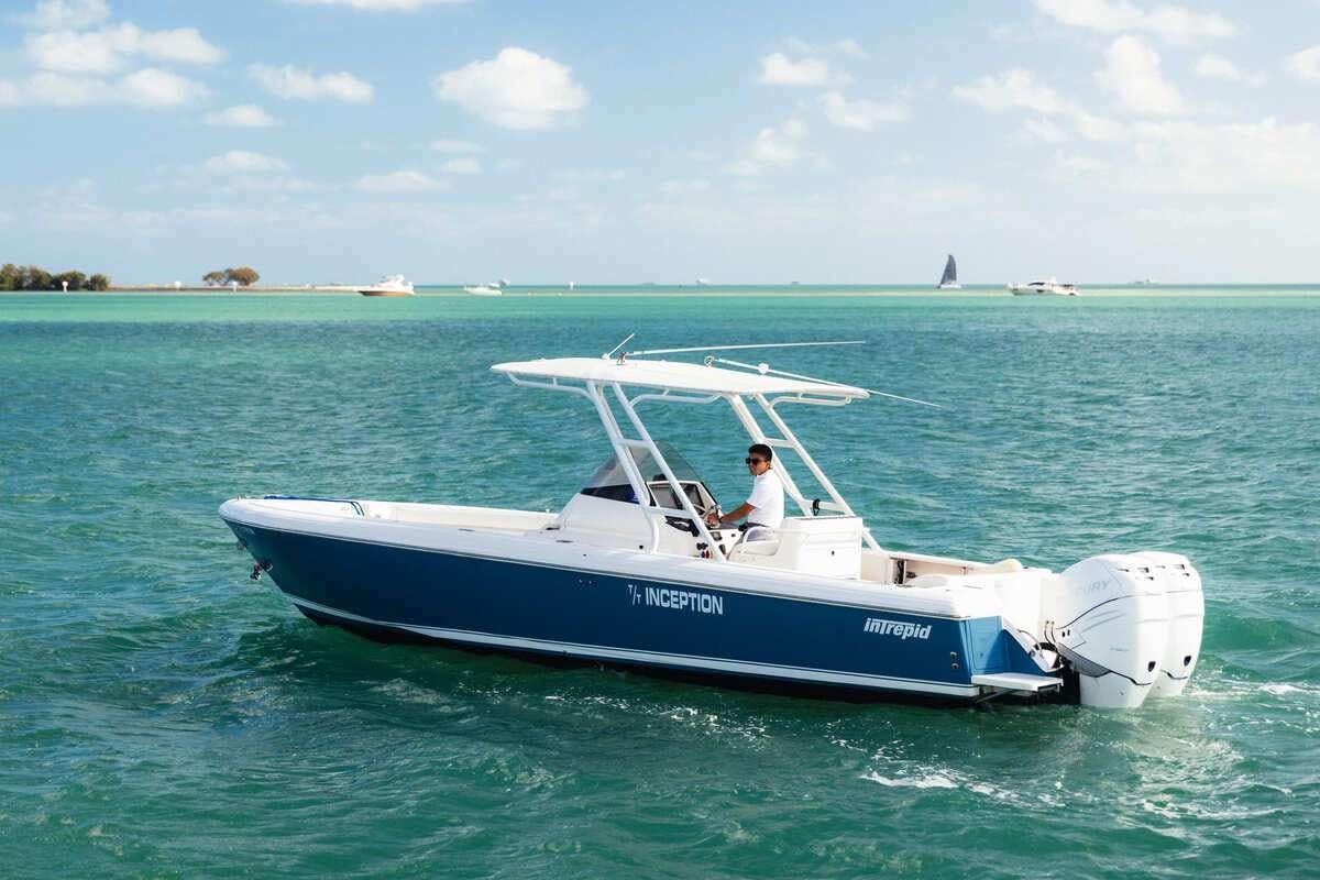 a person driving a boat on the water aboard INCEPTION Yacht for Charter