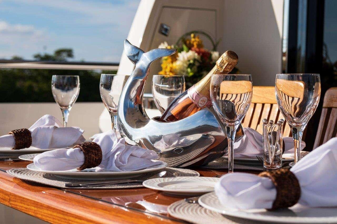 a table with plates and glasses aboard SILVER LINING Yacht for Charter