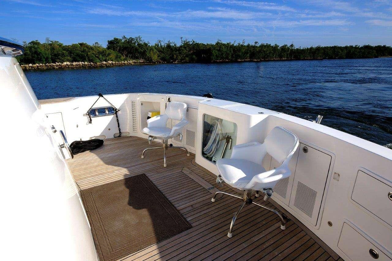 a deck with chairs on it by a body of water aboard SILVER LINING Yacht for Charter