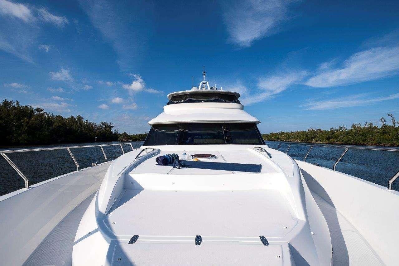 a white boat on a dock aboard SILVER LINING Yacht for Charter