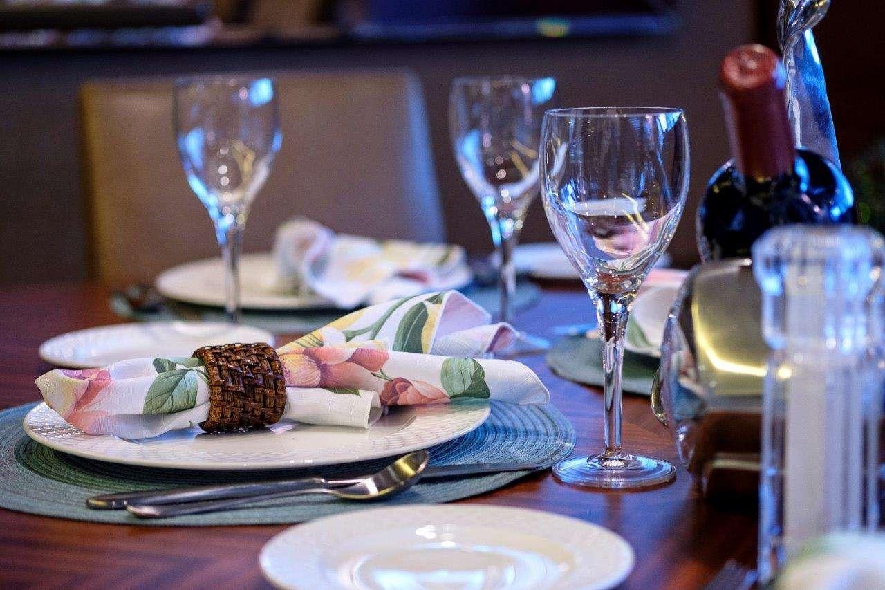 a table with plates and glasses of wine aboard SILVER LINING Yacht for Charter