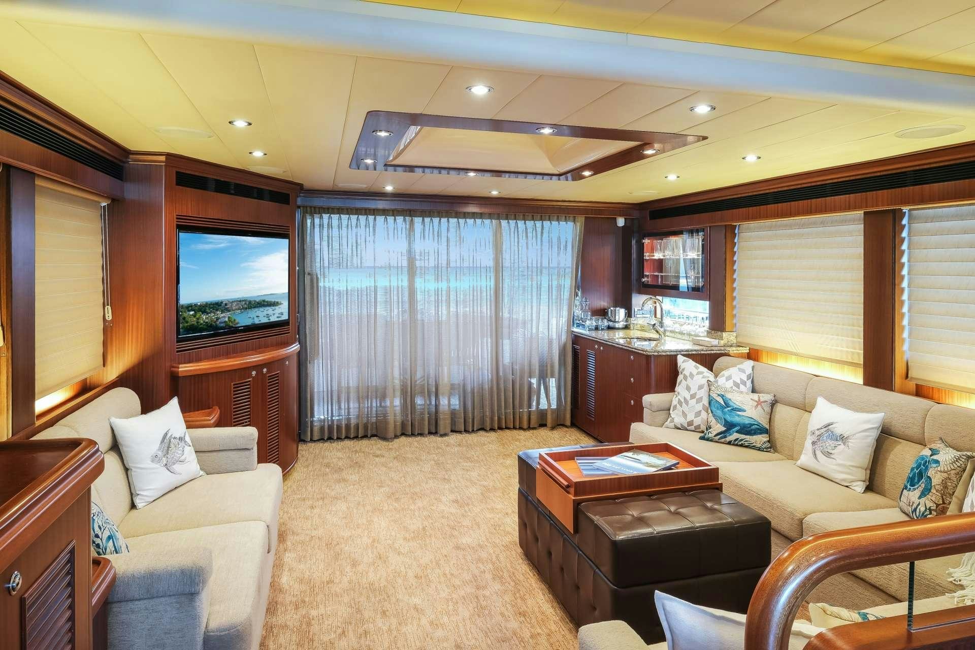 a living room with a large window aboard SILVER LINING Yacht for Charter