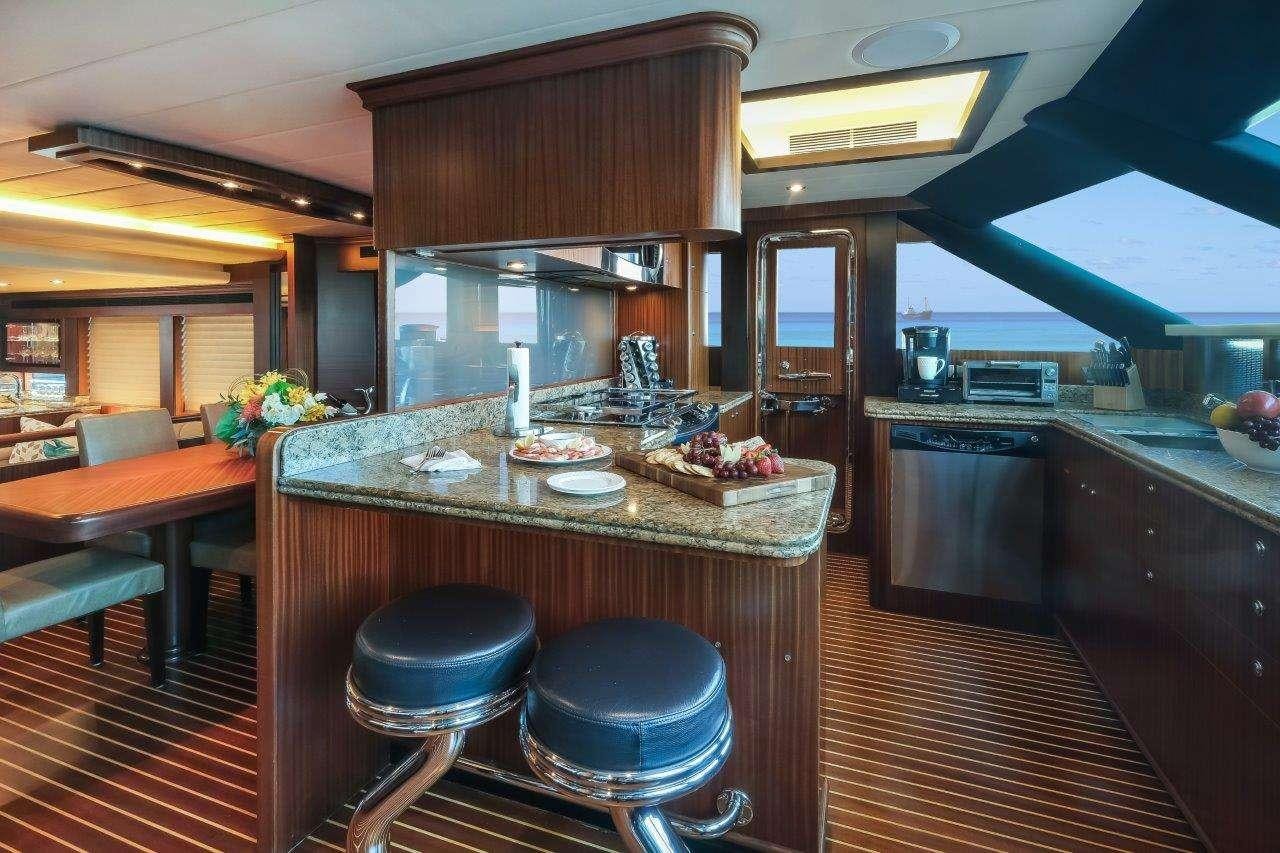 a kitchen with a table and chairs aboard SILVER LINING Yacht for Charter