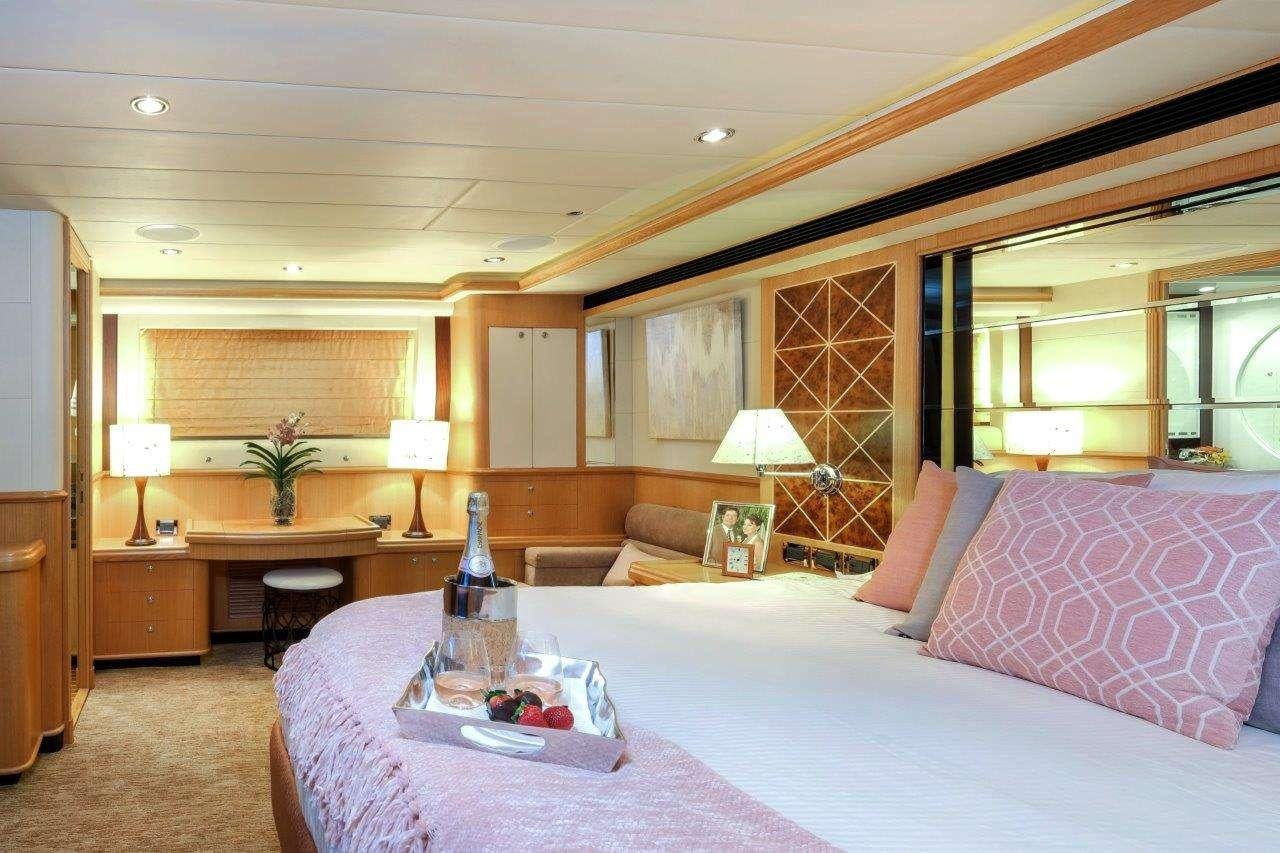 a large bedroom with a bed and a couch aboard SILVER LINING Yacht for Charter