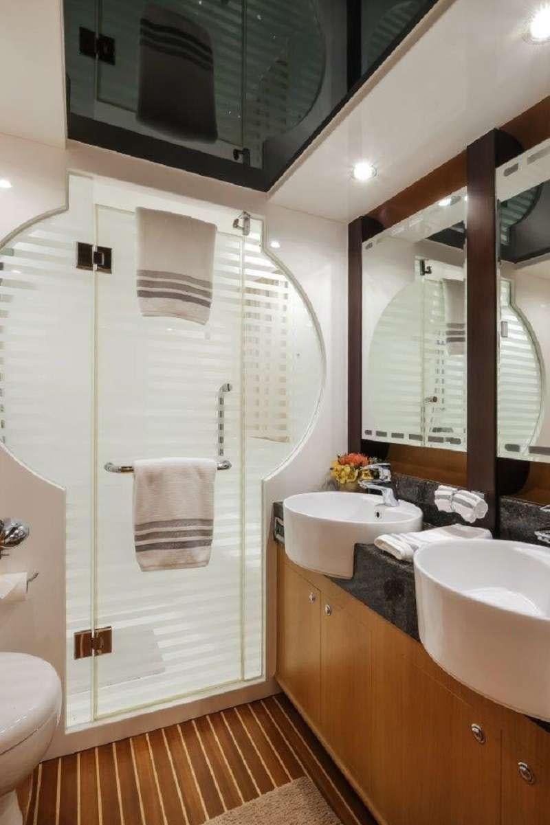 a bathroom with a shower and sink aboard SILVER LINING Yacht for Charter