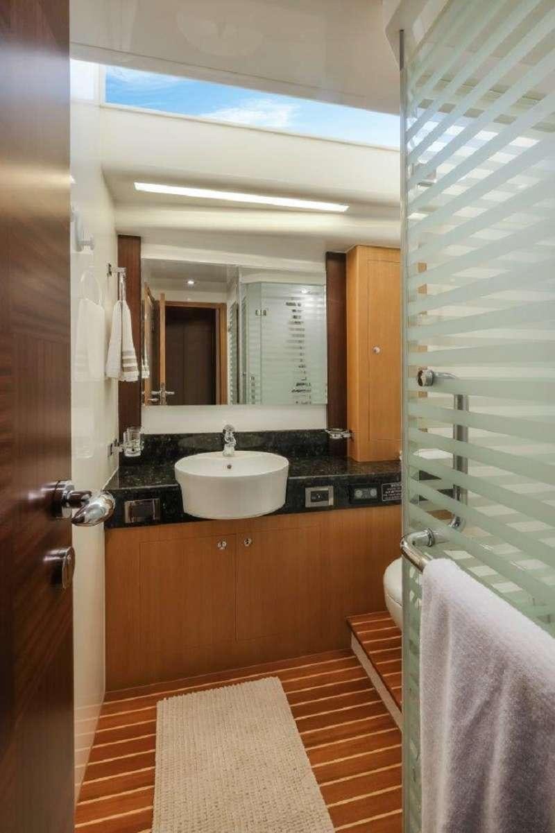 a bathroom with a sink and a shower aboard SILVER LINING Yacht for Charter