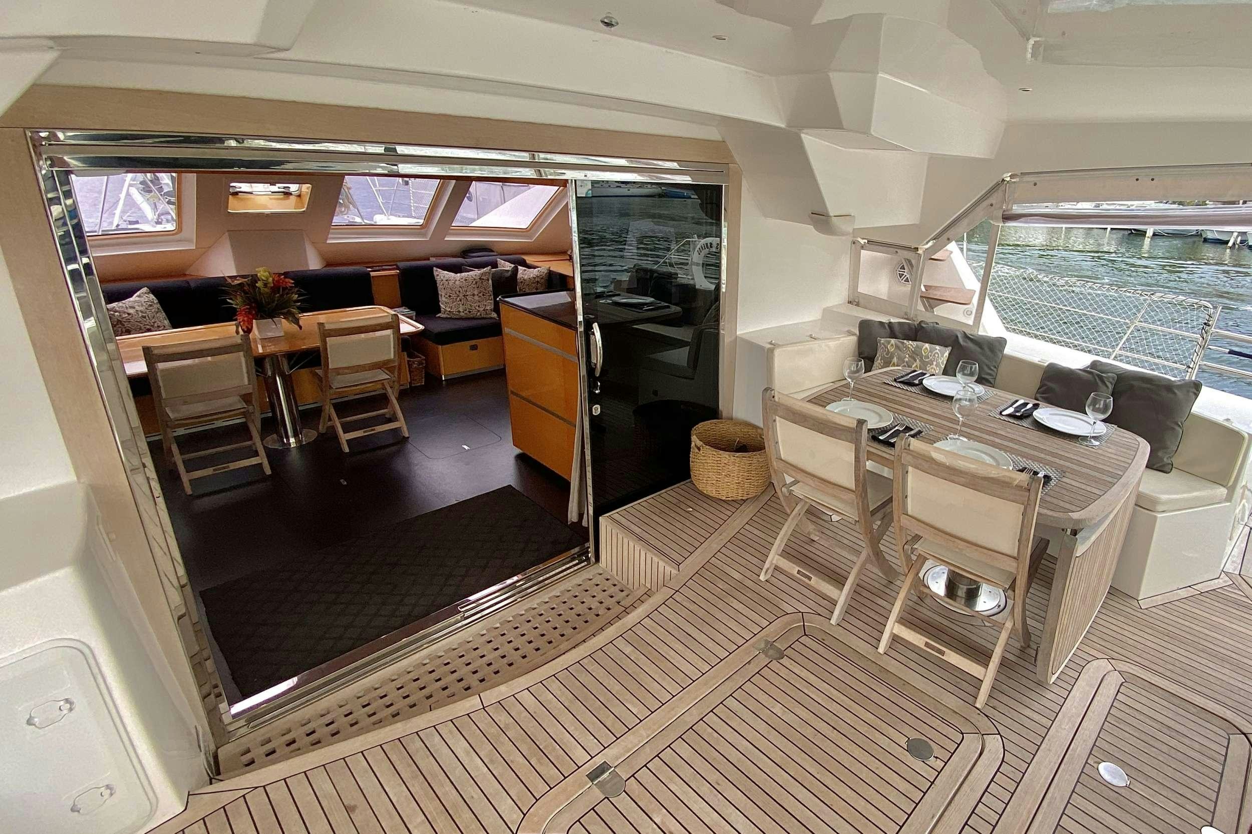 a room with a table and chairs aboard TRES SUENOS Yacht for Charter
