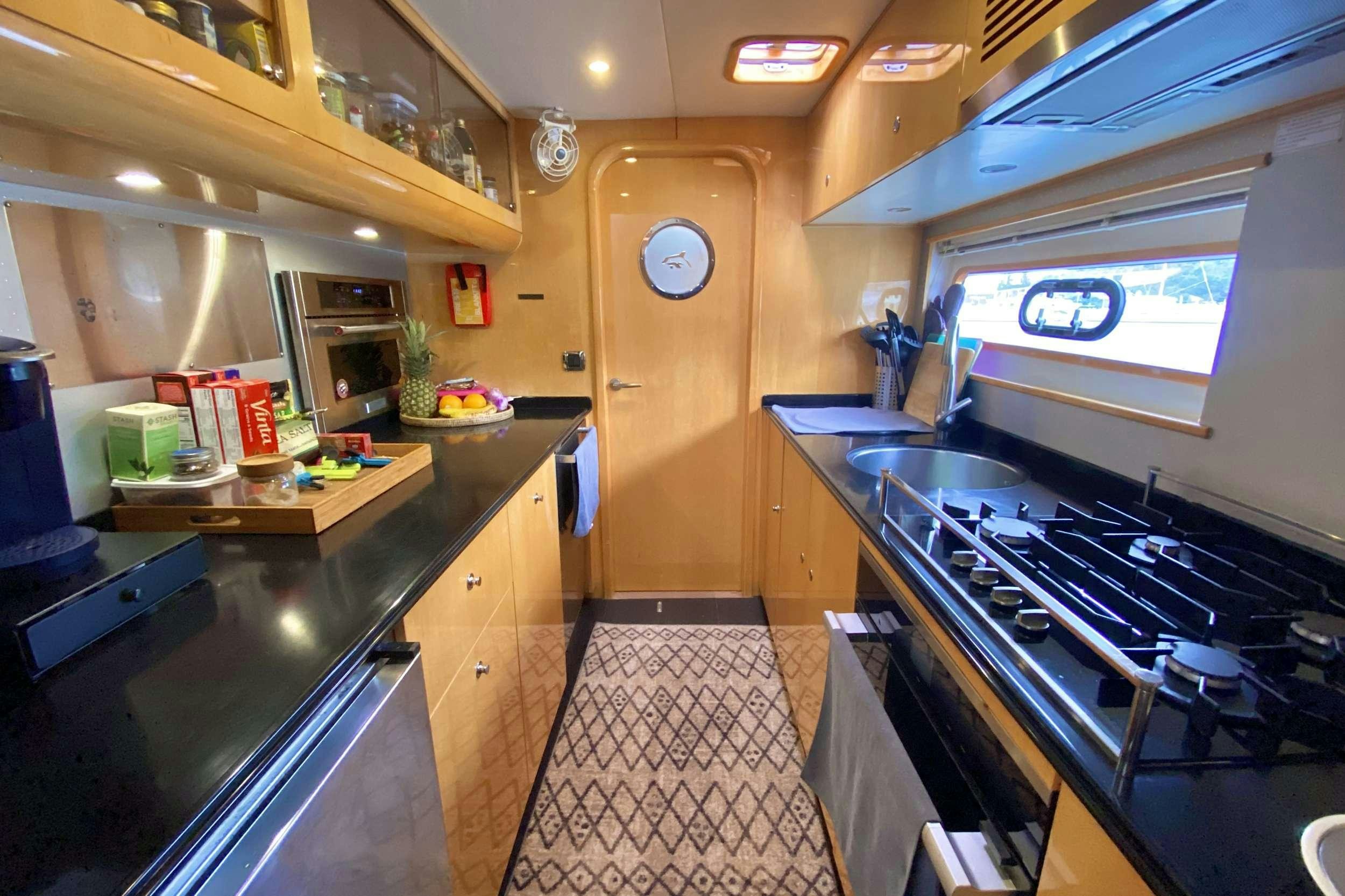 a kitchen with a large island aboard TRES SUENOS Yacht for Charter