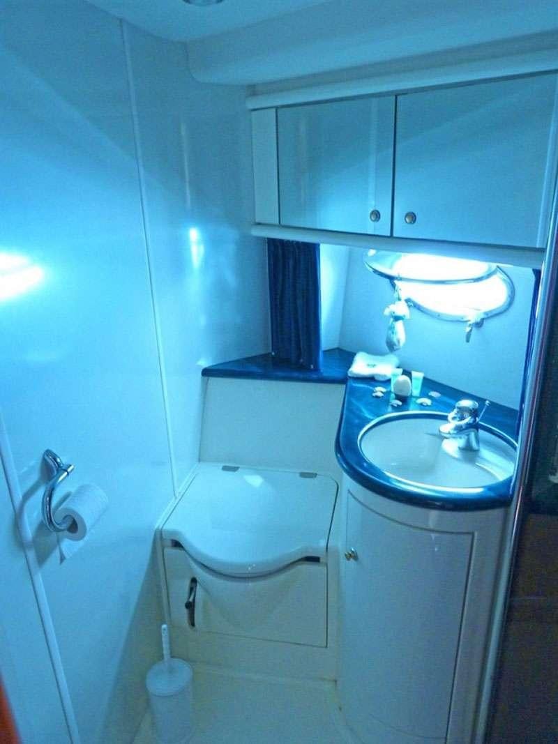 a bathroom with a sink and a mirror aboard OBSESSION Yacht for Charter
