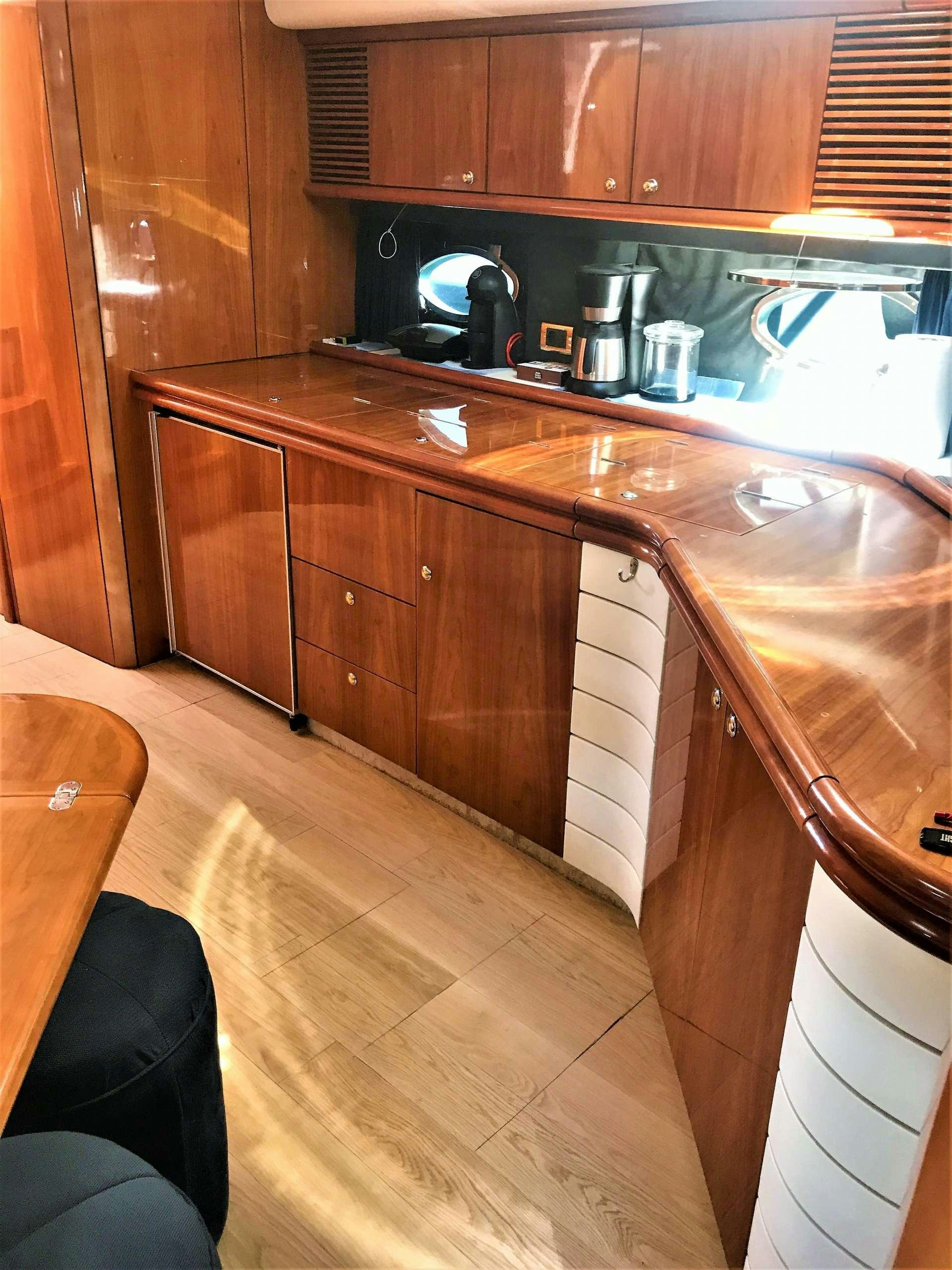 a kitchen with wooden cabinets aboard OBSESSION Yacht for Charter