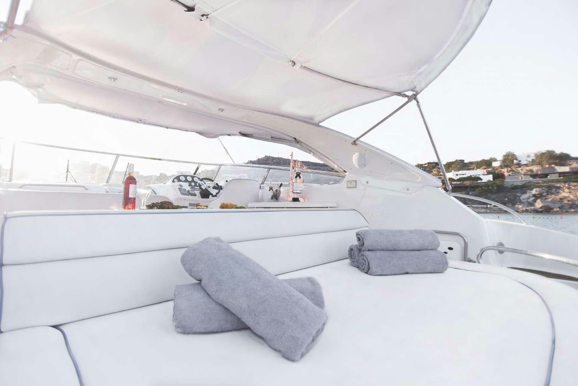a white tent with a person standing on the deck aboard AEGEAN BLUE Yacht for Charter