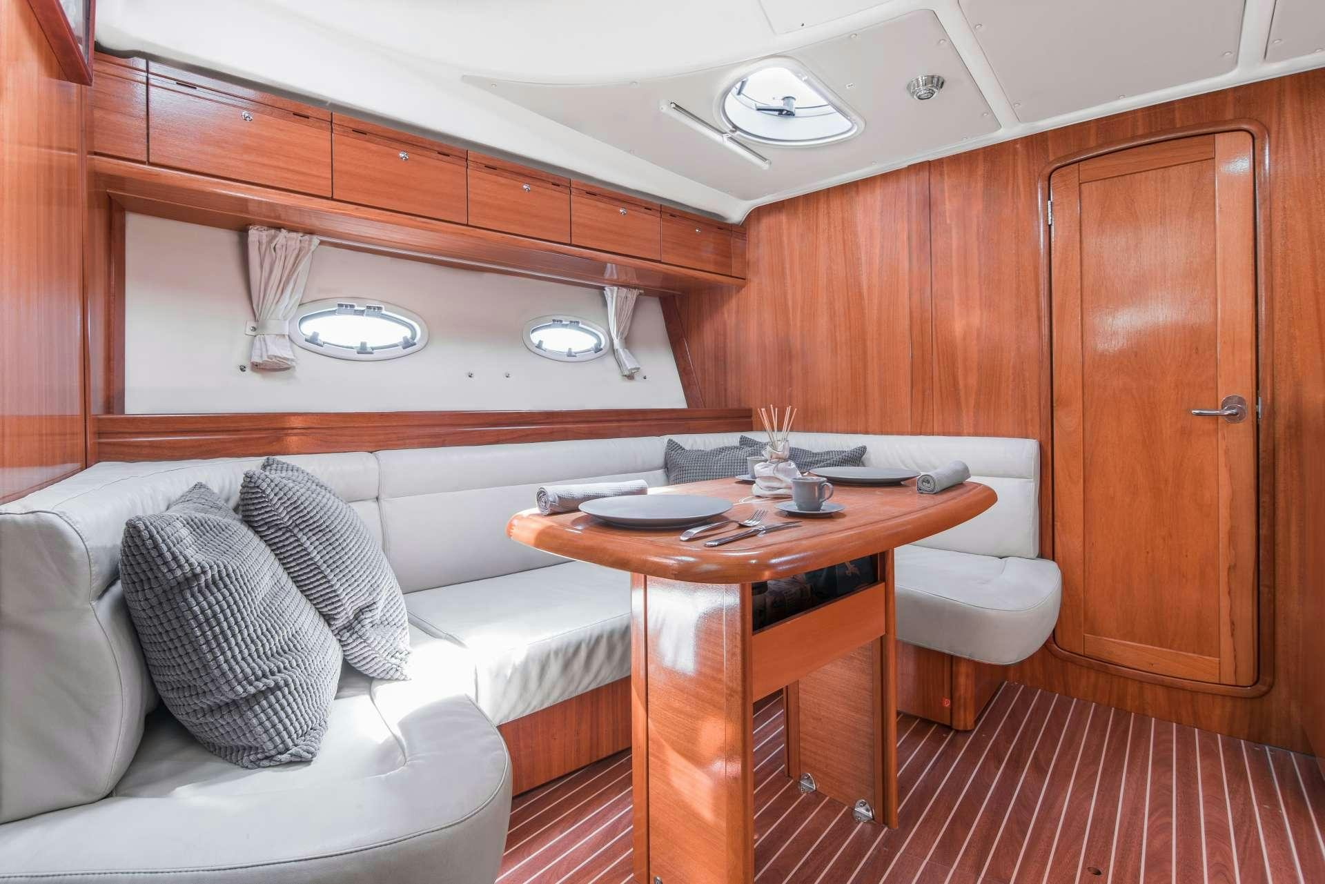 a room with a couch and a table aboard AEGEAN BLUE Yacht for Charter