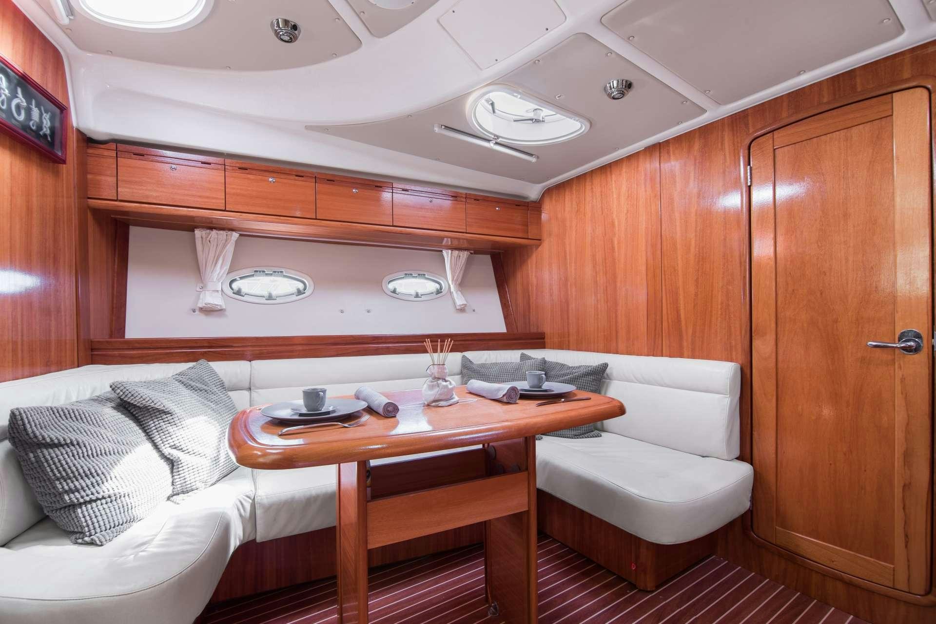 a room with a couch and a table aboard AEGEAN BLUE Yacht for Charter