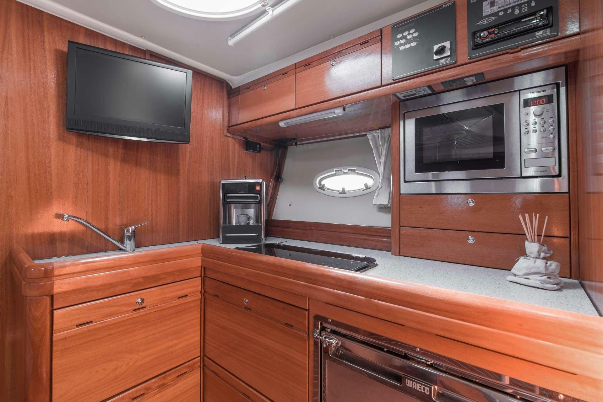 a kitchen with wooden cabinets aboard AEGEAN BLUE Yacht for Charter