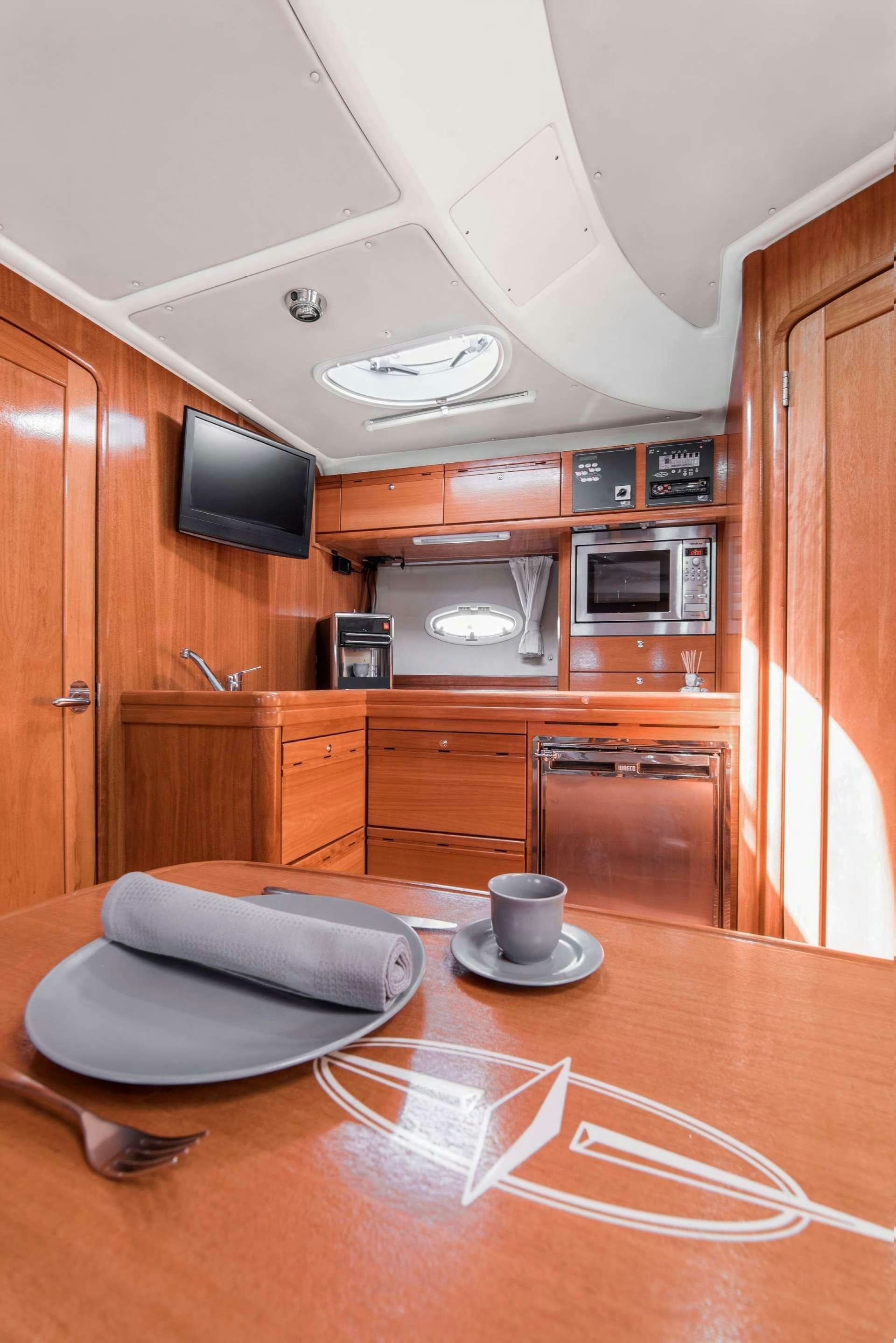a kitchen with a microwave oven and a coffee table aboard AEGEAN BLUE Yacht for Charter