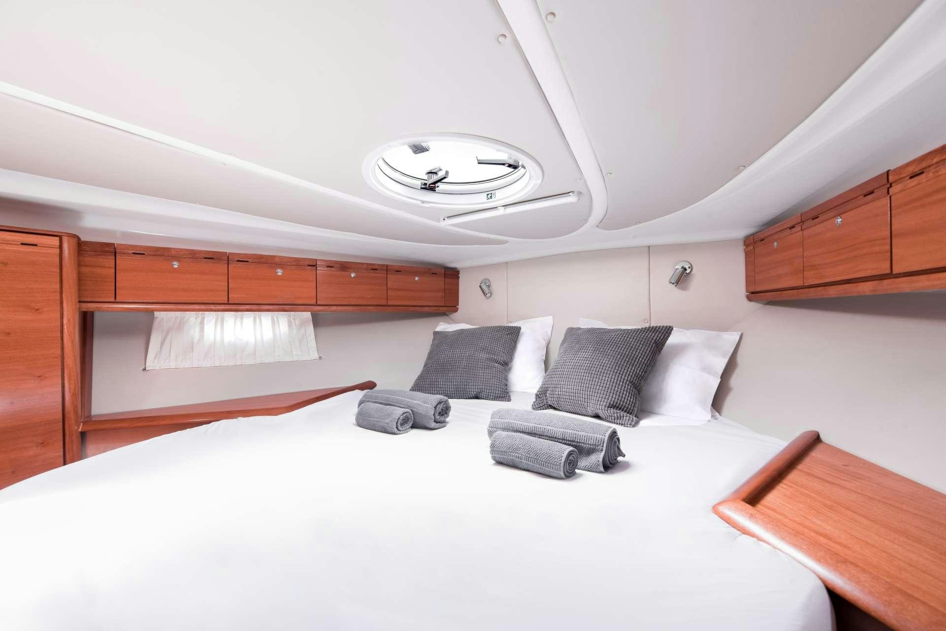 a bed with pillows on it aboard AEGEAN BLUE Yacht for Charter