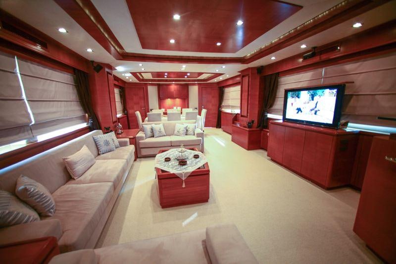 a living room with a large screen aboard MERVE Yacht for Charter