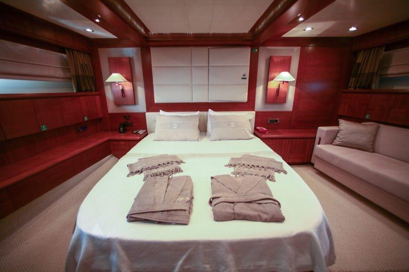 a room with a bed and a couch aboard MERVE Yacht for Charter