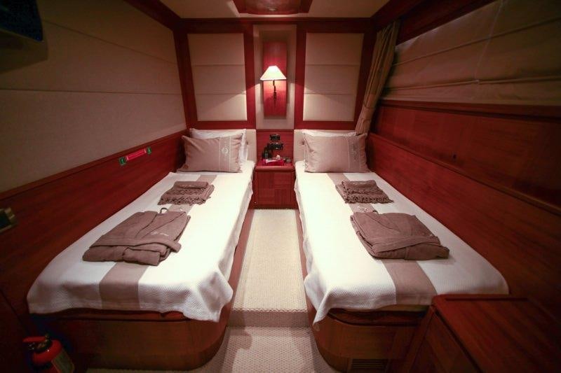 a couple of beds in a room aboard MERVE Yacht for Charter