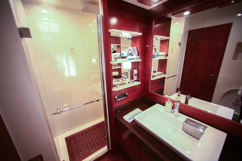 a bathroom with a large mirror aboard MERVE Yacht for Charter