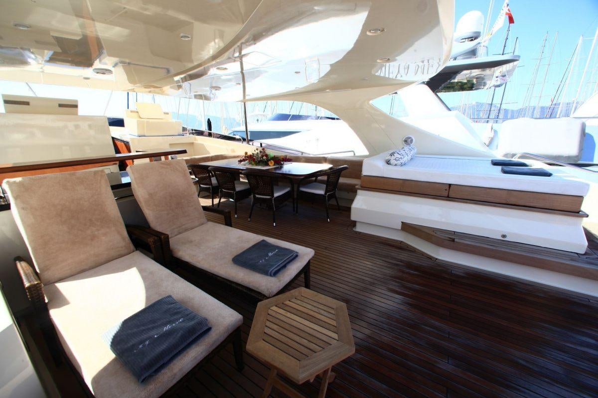a room with a desk and chairs aboard MERVE Yacht for Charter