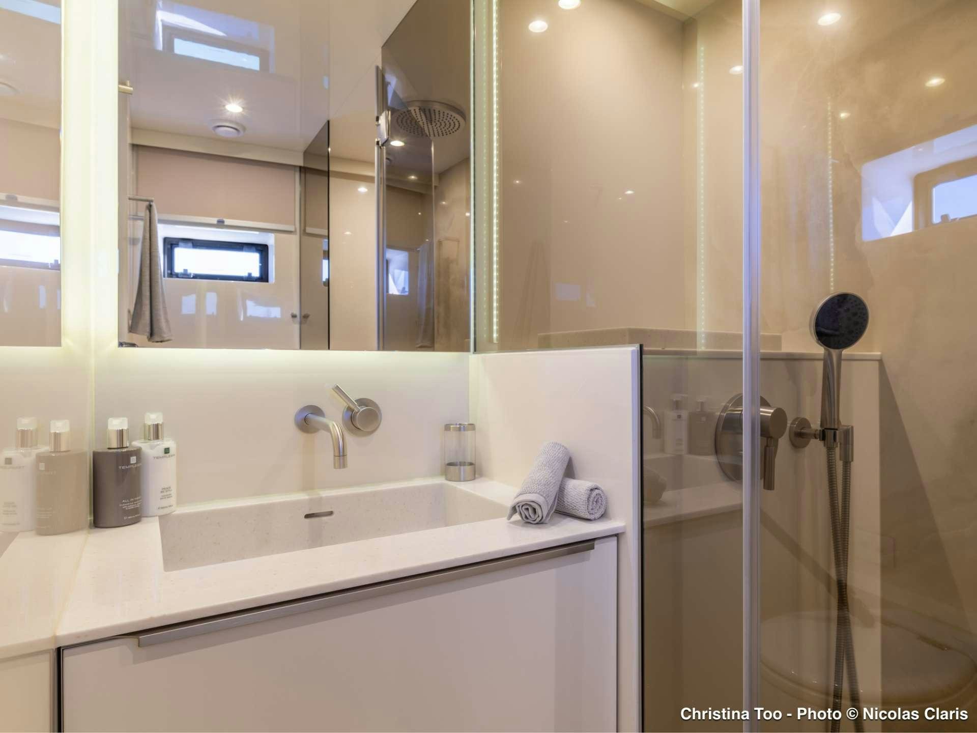 a bathroom with a glass shower aboard CHRISTINA TOO Yacht for Sale