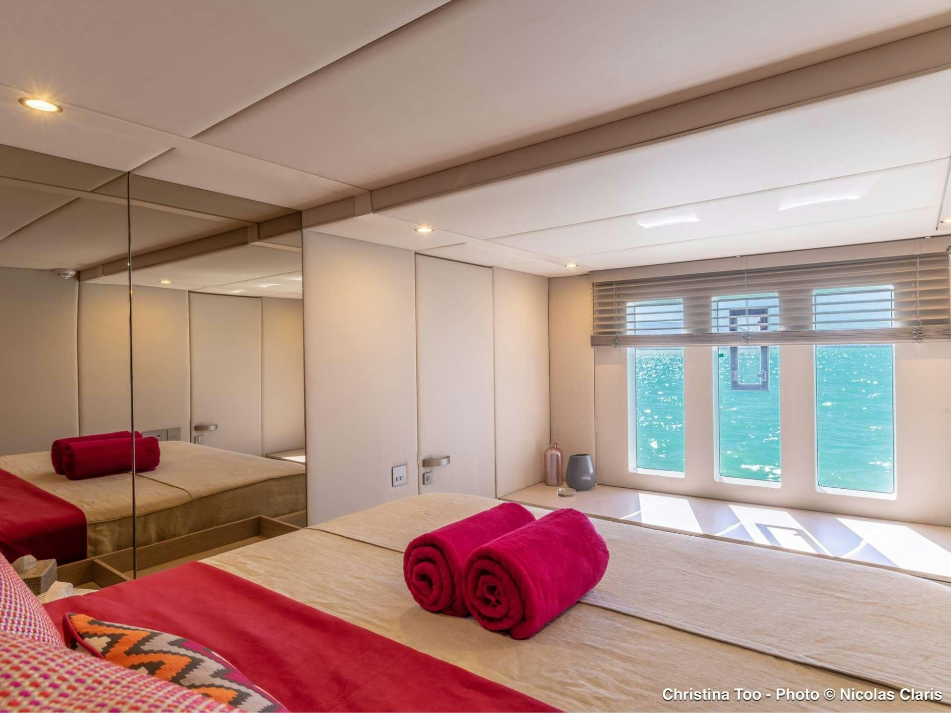 a room with a bed and a red rug aboard CHRISTINA TOO Yacht for Sale
