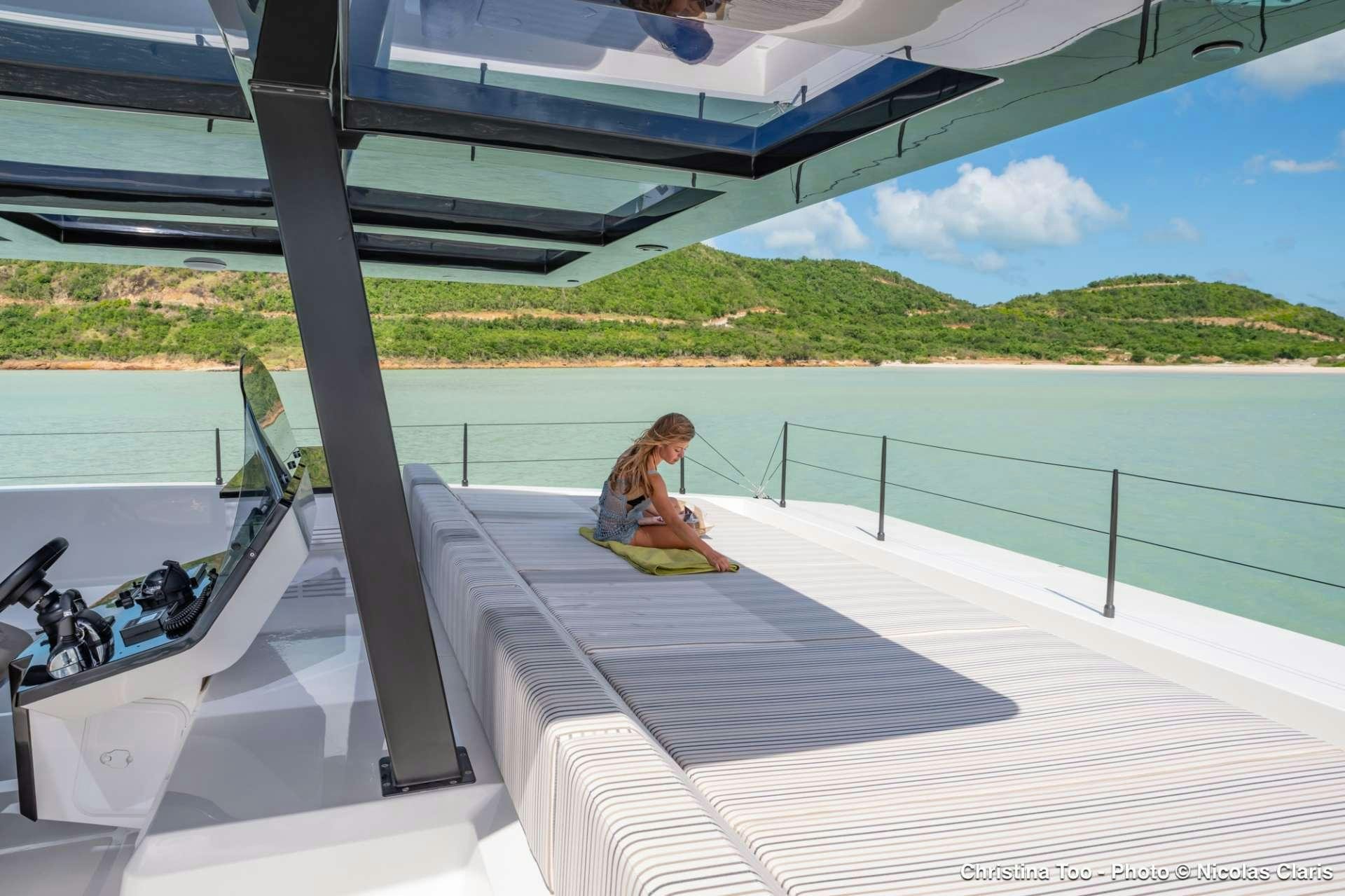 a person sitting on a deck aboard CHRISTINA TOO Yacht for Charter