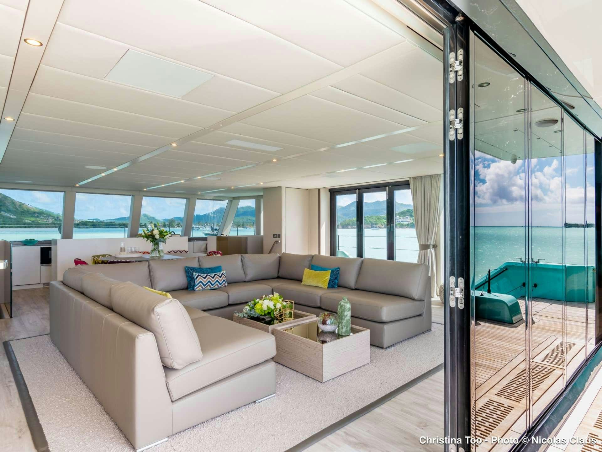 a living room with a glass door aboard CHRISTINA TOO Yacht for Sale