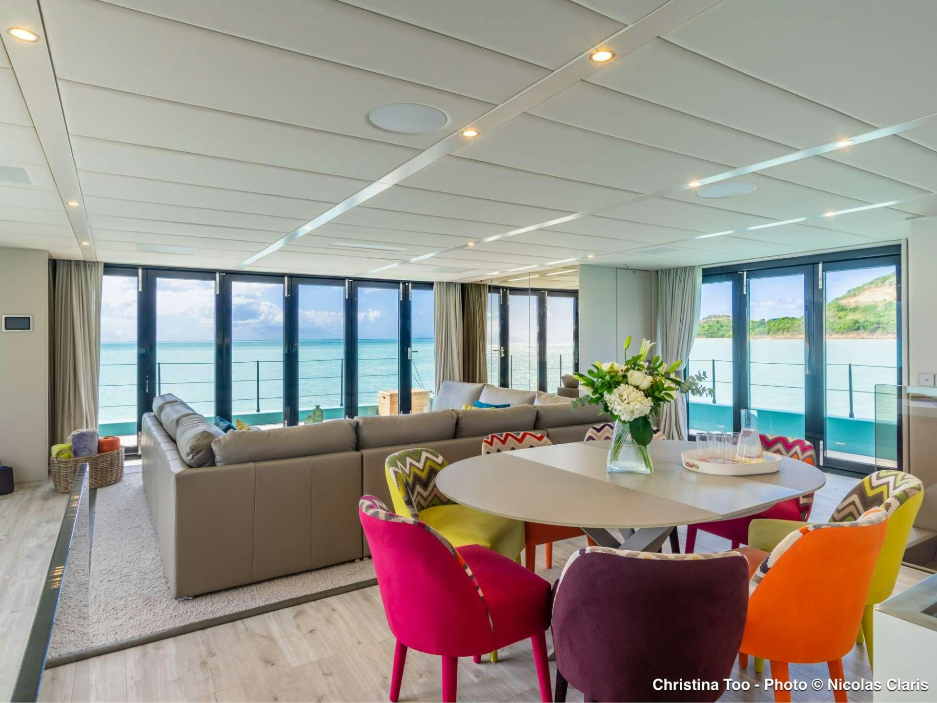a living room with a large window aboard CHRISTINA TOO Yacht for Sale
