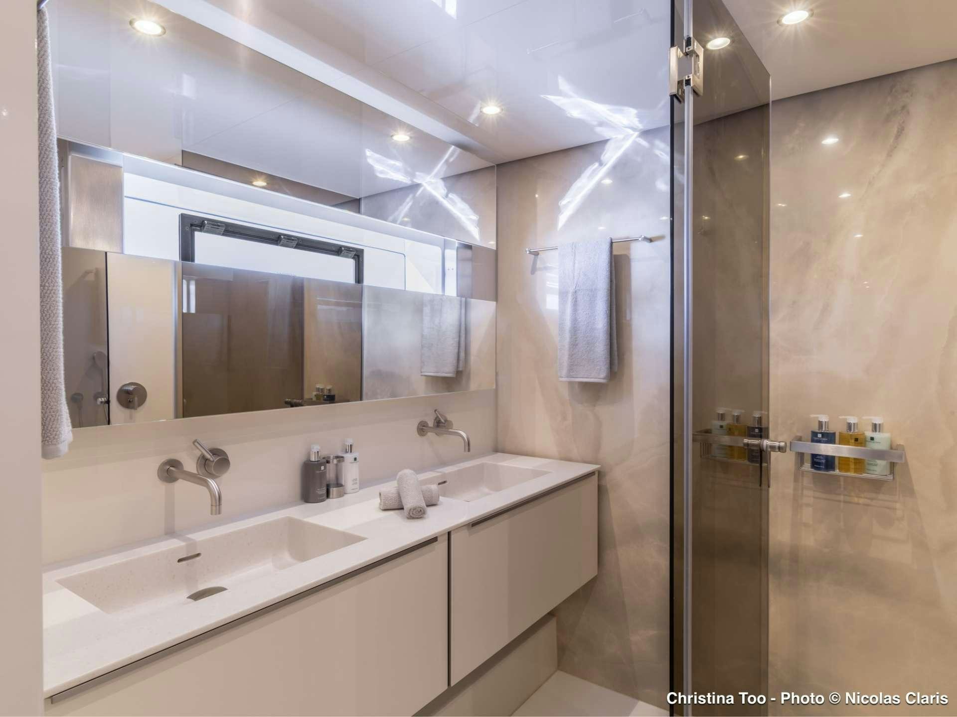 a bathroom with a sink and a mirror aboard CHRISTINA TOO Yacht for Sale