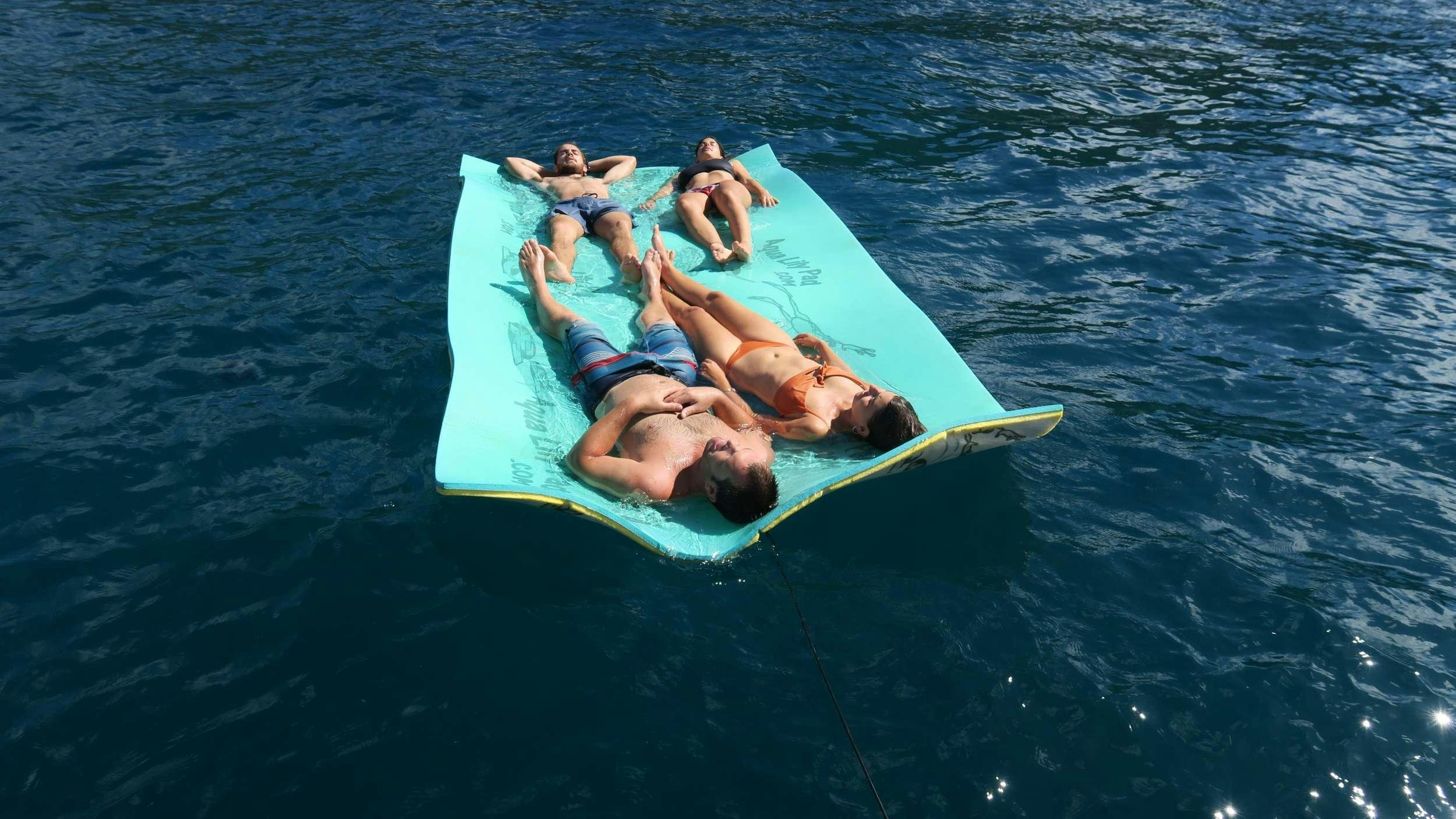 a group of people on a raft in the water aboard NEMO Yacht for Charter