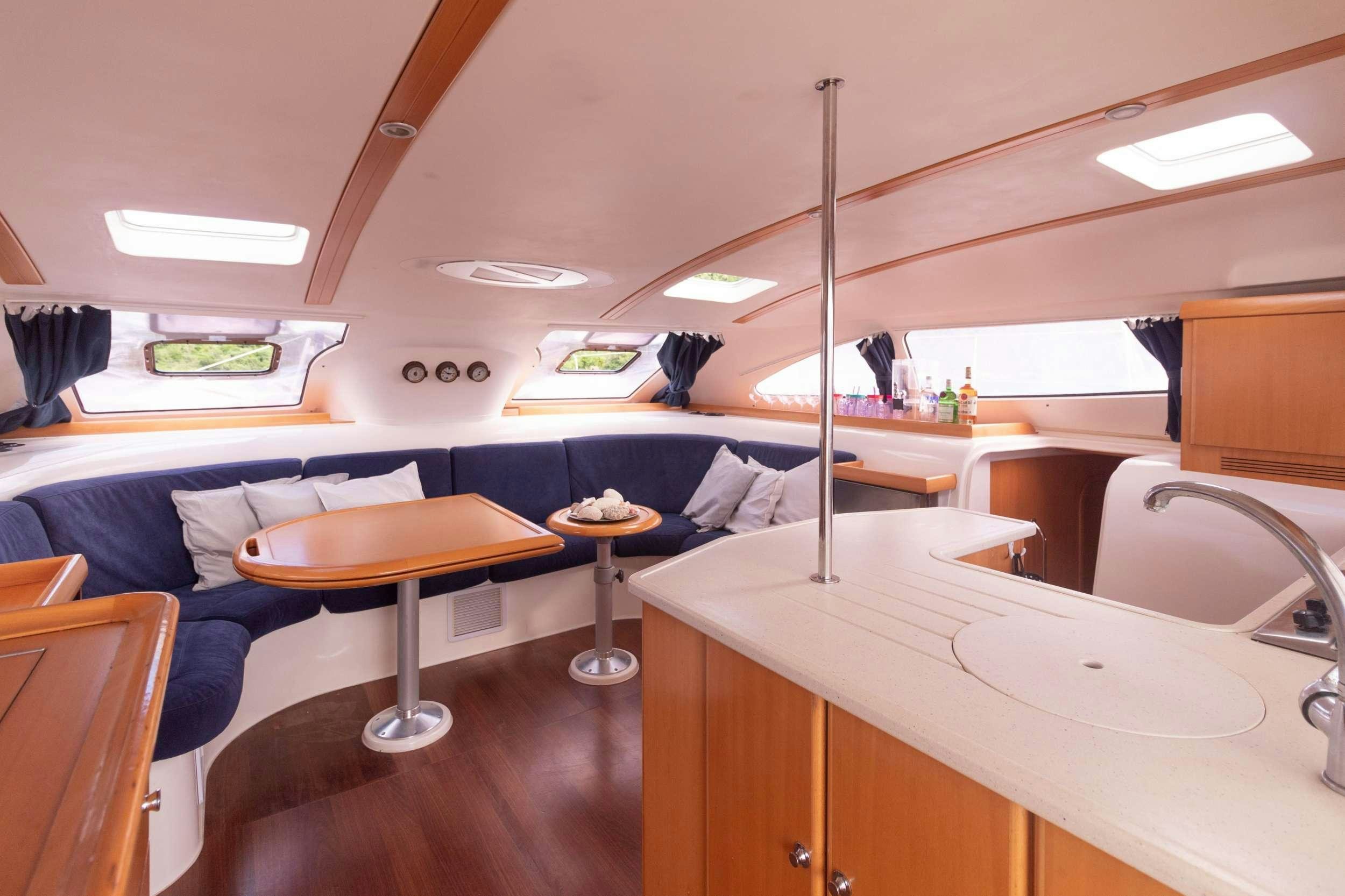 a room with a bed and a table aboard NEMO Yacht for Charter