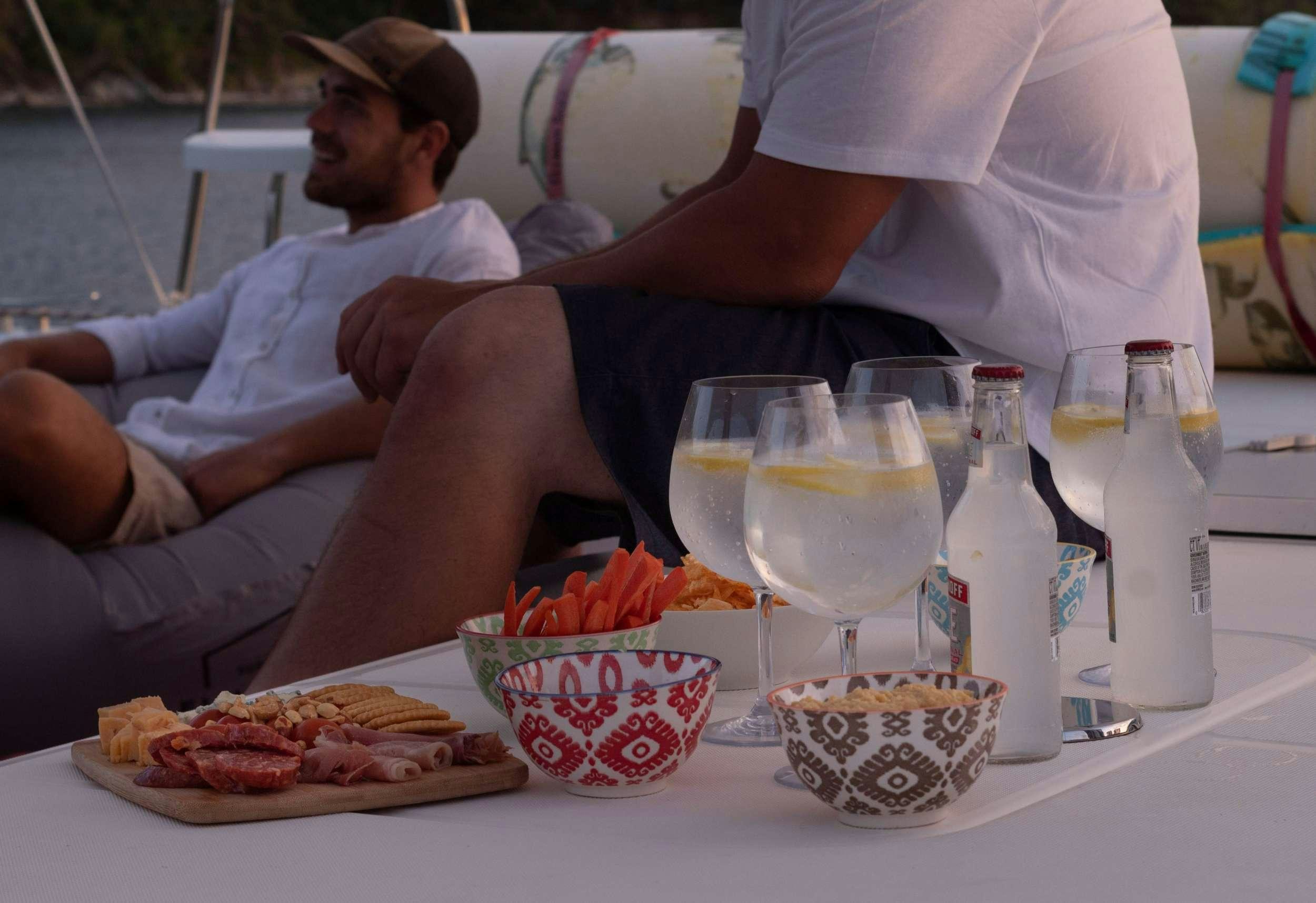 a person eating pizza at a table aboard NEMO Yacht for Charter