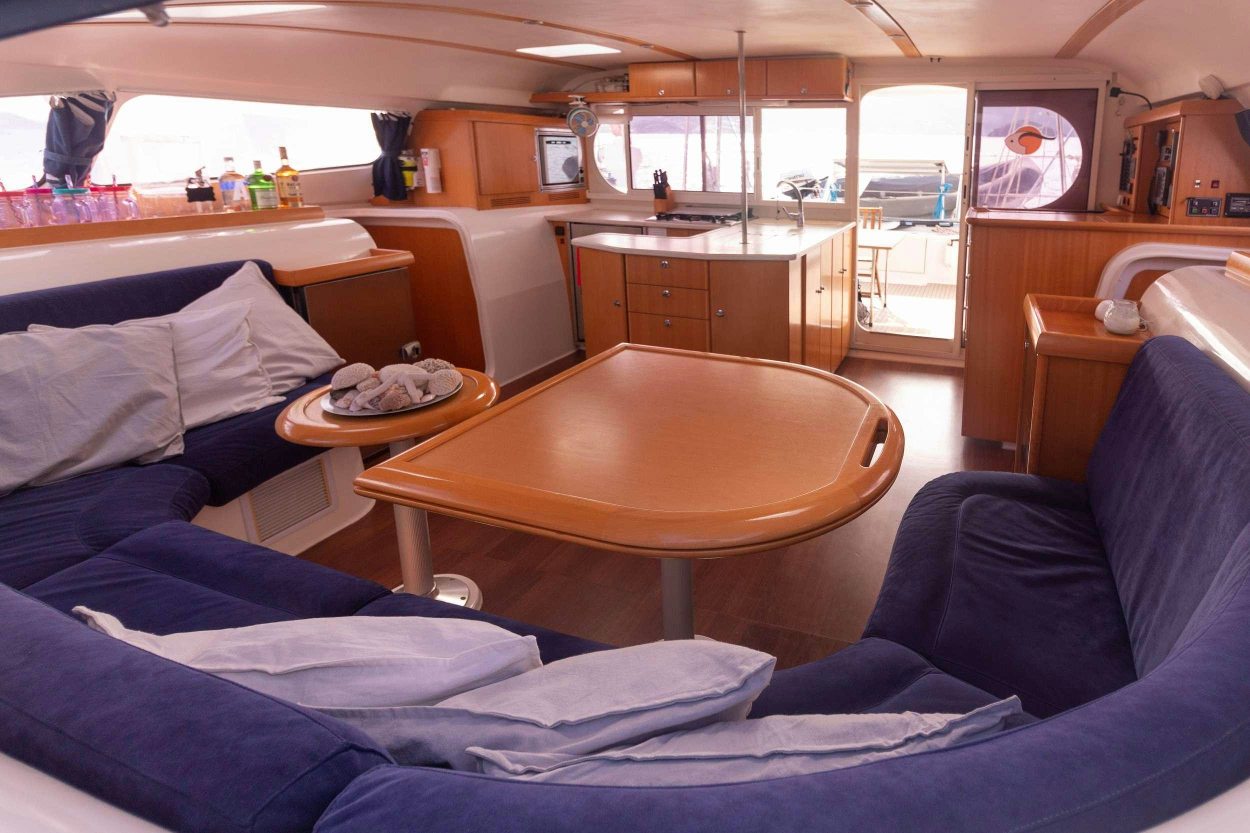 a room with a table and chairs aboard NEMO Yacht for Charter