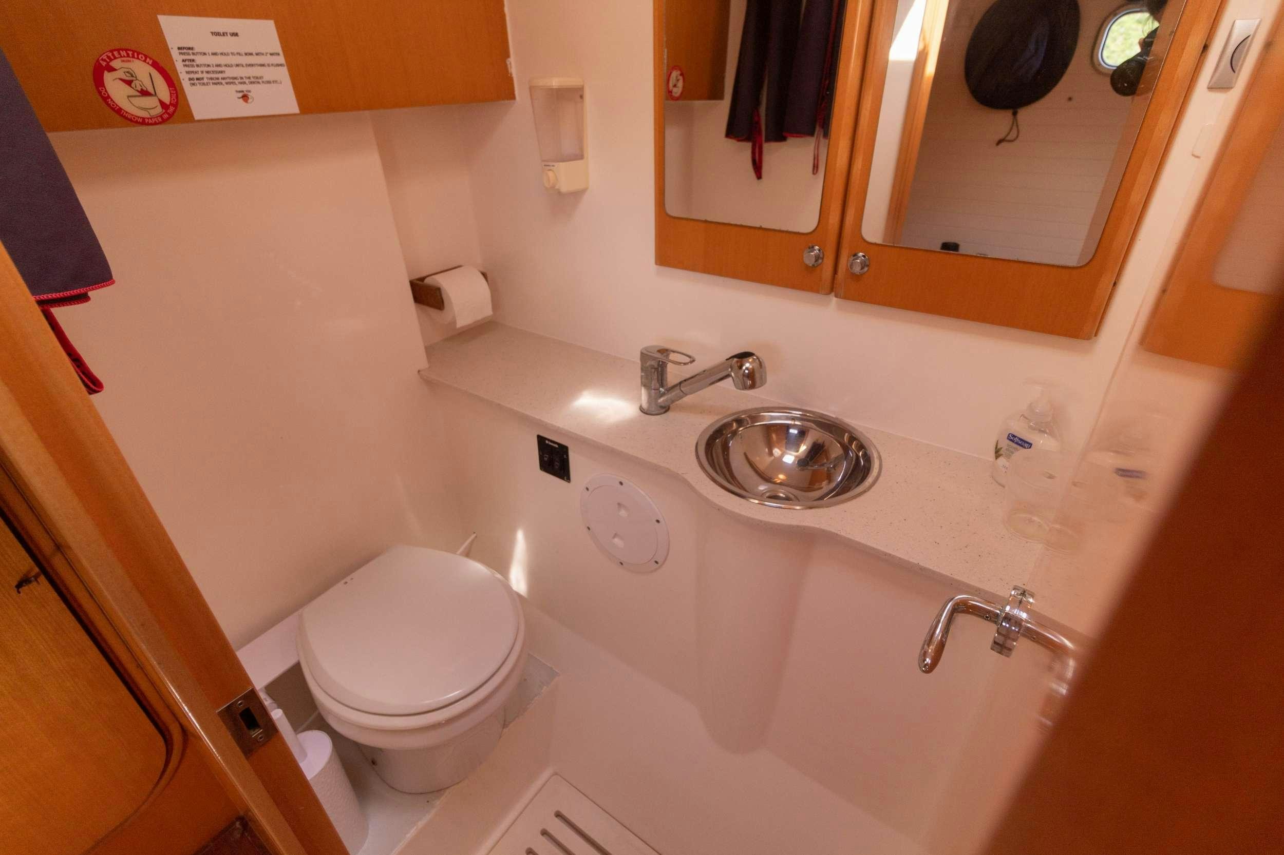 a bathroom with a toilet and a sink aboard NEMO Yacht for Charter