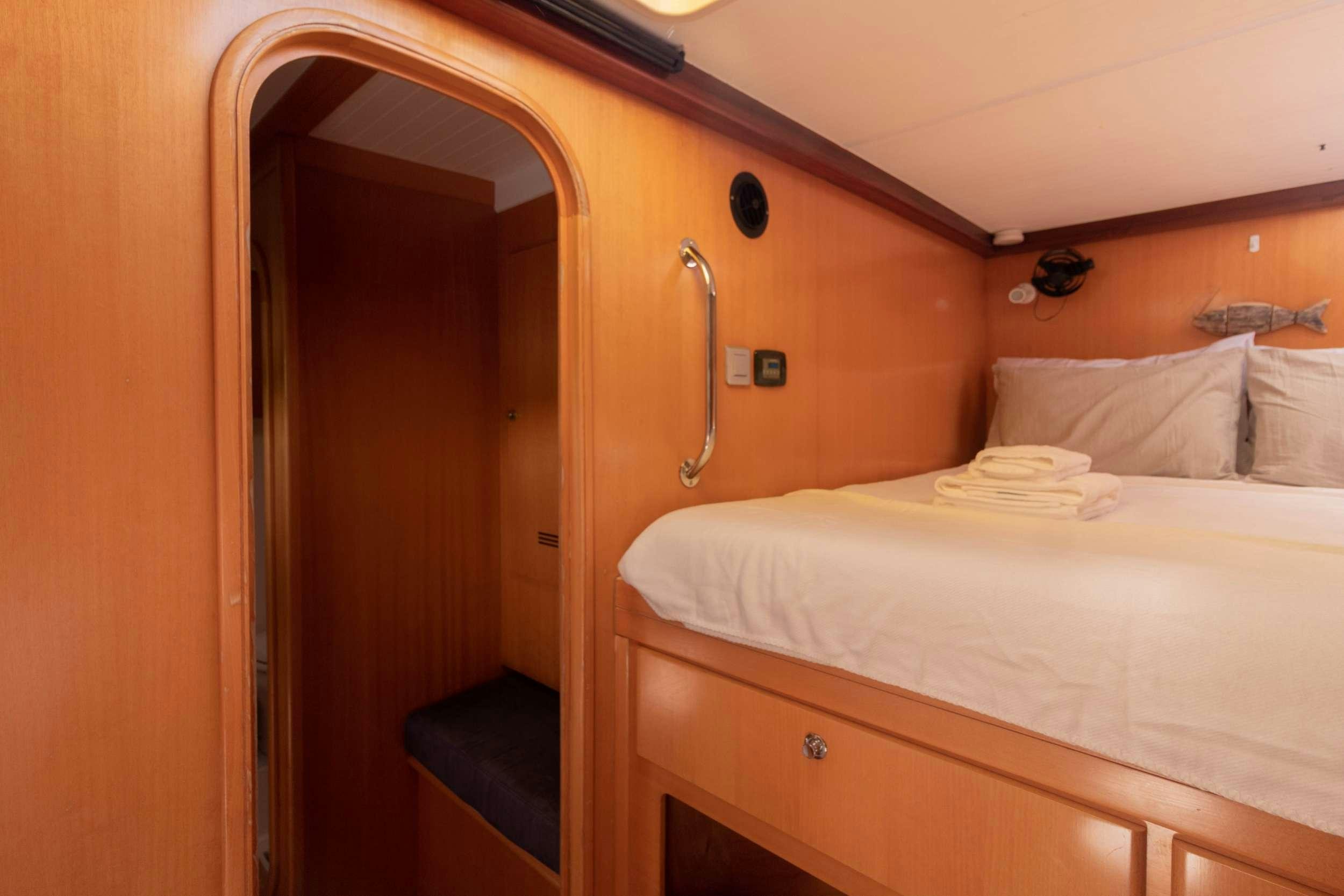 a hotel room with a bed aboard NEMO Yacht for Charter