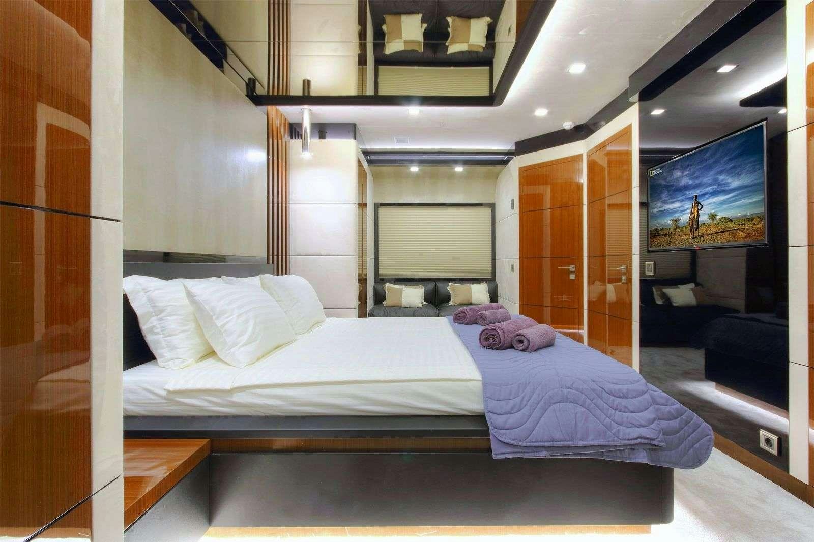 a room with a bed and a mirror aboard MOSS Yacht for Charter