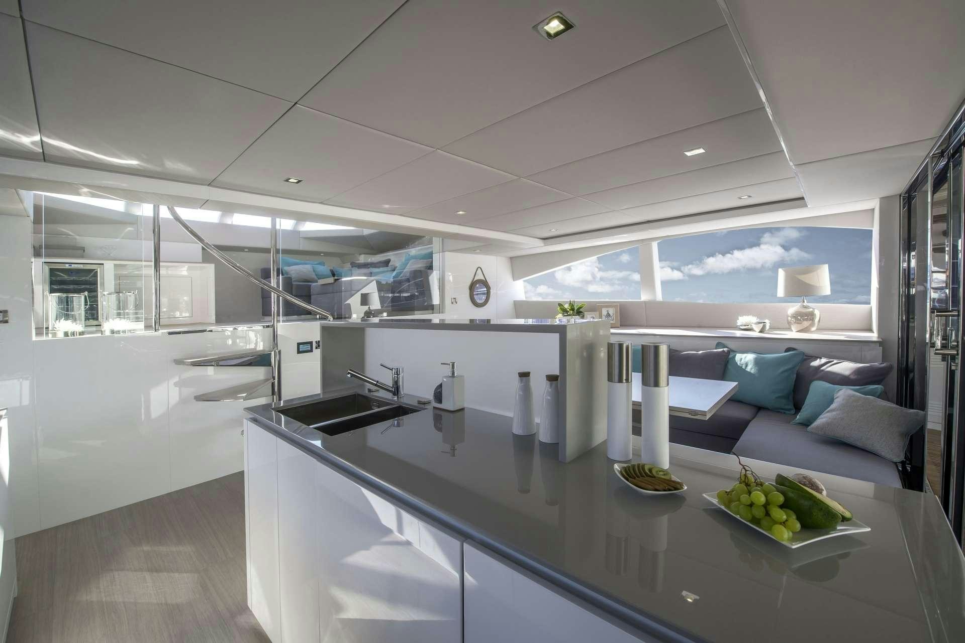 a kitchen with a large island aboard MOONDANCE Yacht for Charter