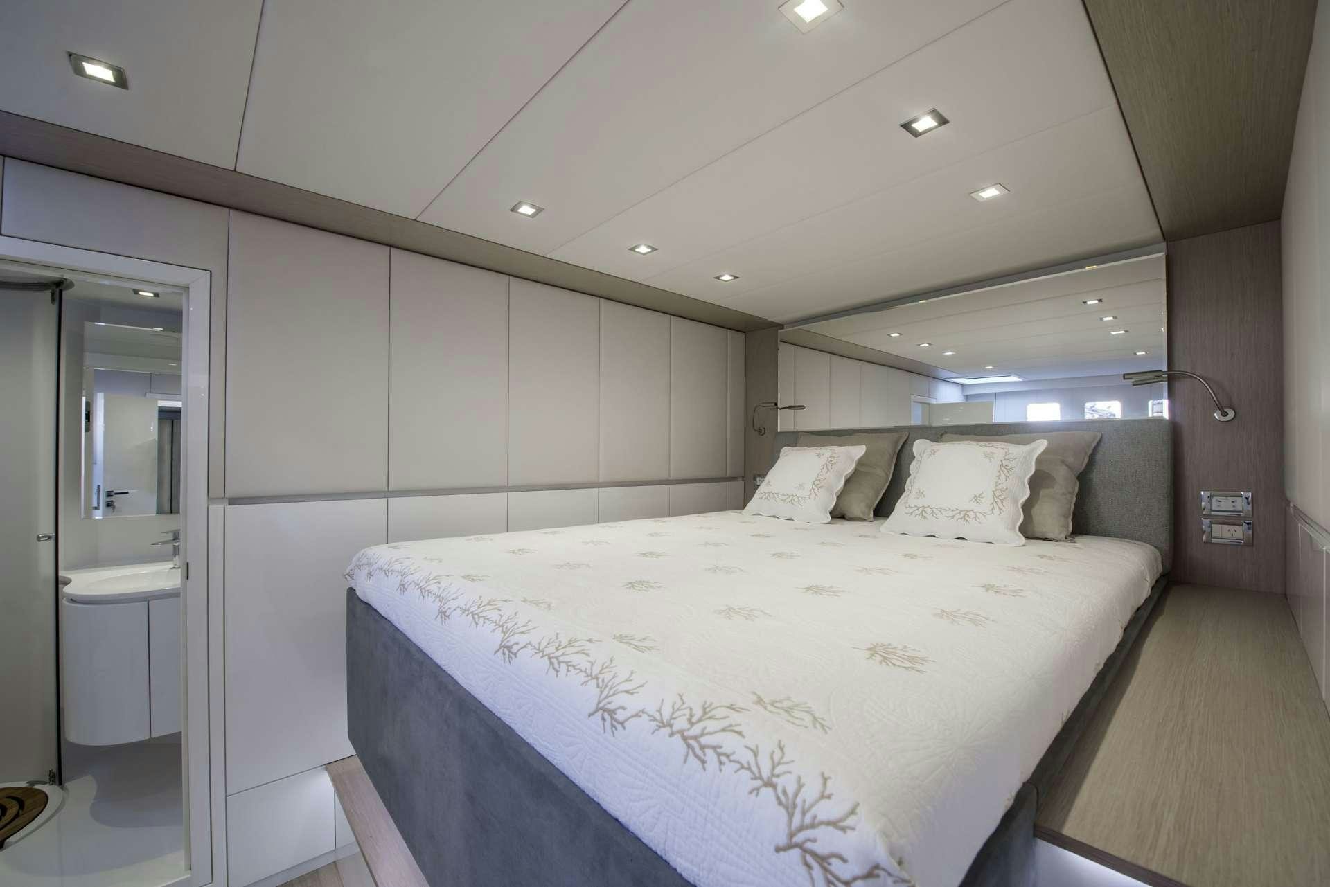 a large white bed in a room aboard MOONDANCE Yacht for Charter